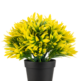 De Kunstplant Yellow sun in pot UV 22 cm heeft een zwarte bloempot met een dichte, kunstplant met puntige gele en groene bladeren, perfect om elke ruimte op te fleuren.