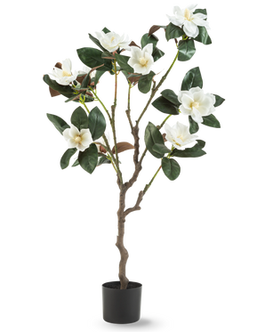 De Kunstplant Yulania 120 cm met bloem is een kunstmagnoliaboom in pot met meerdere takken, grote glanzende groene bladeren en verschillende witte bloemen tegen een effen witte achtergrond.